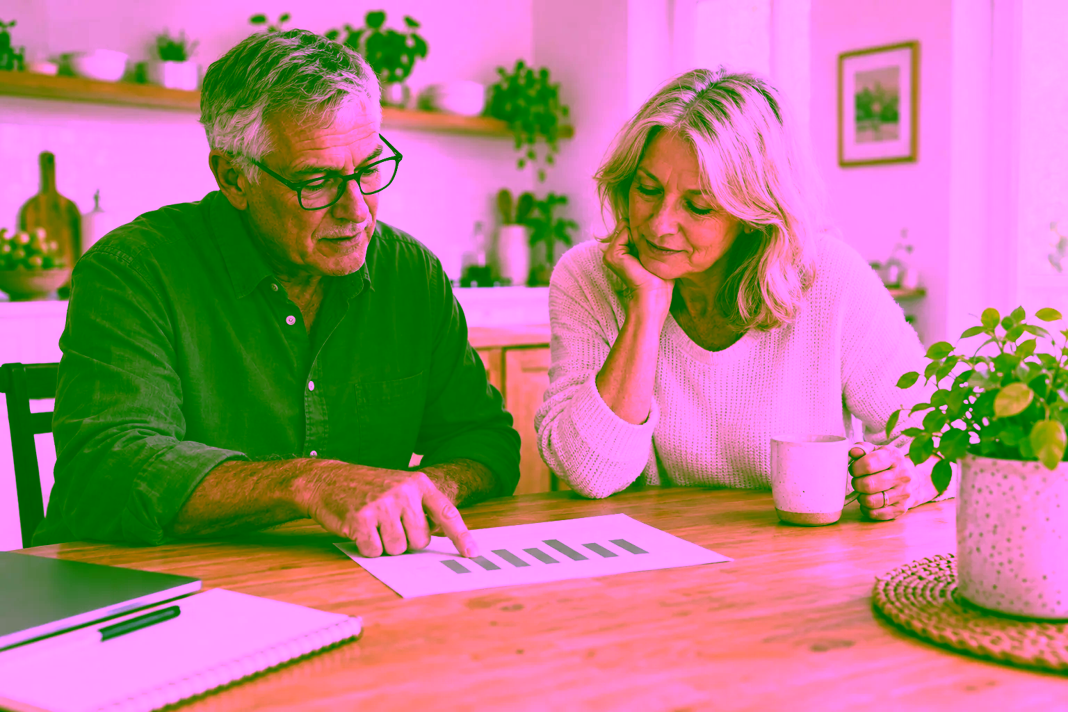 Older couple reviewing a printed bar chart at home